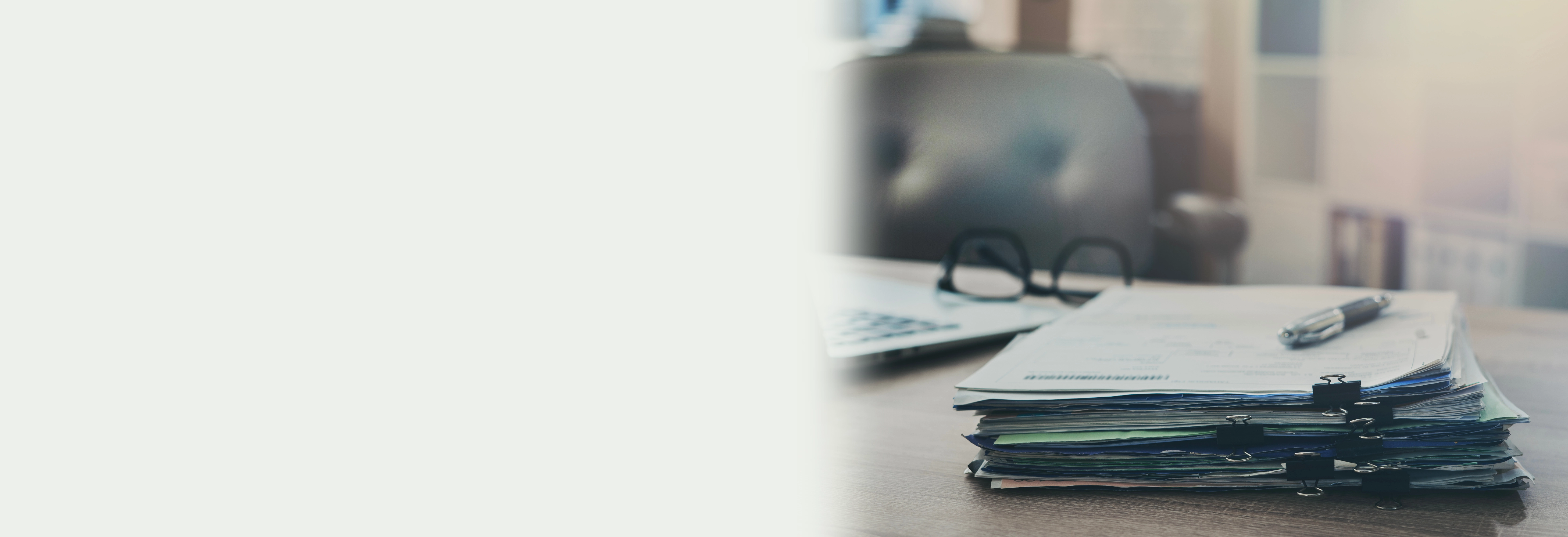 Stack of papers on wooden desk