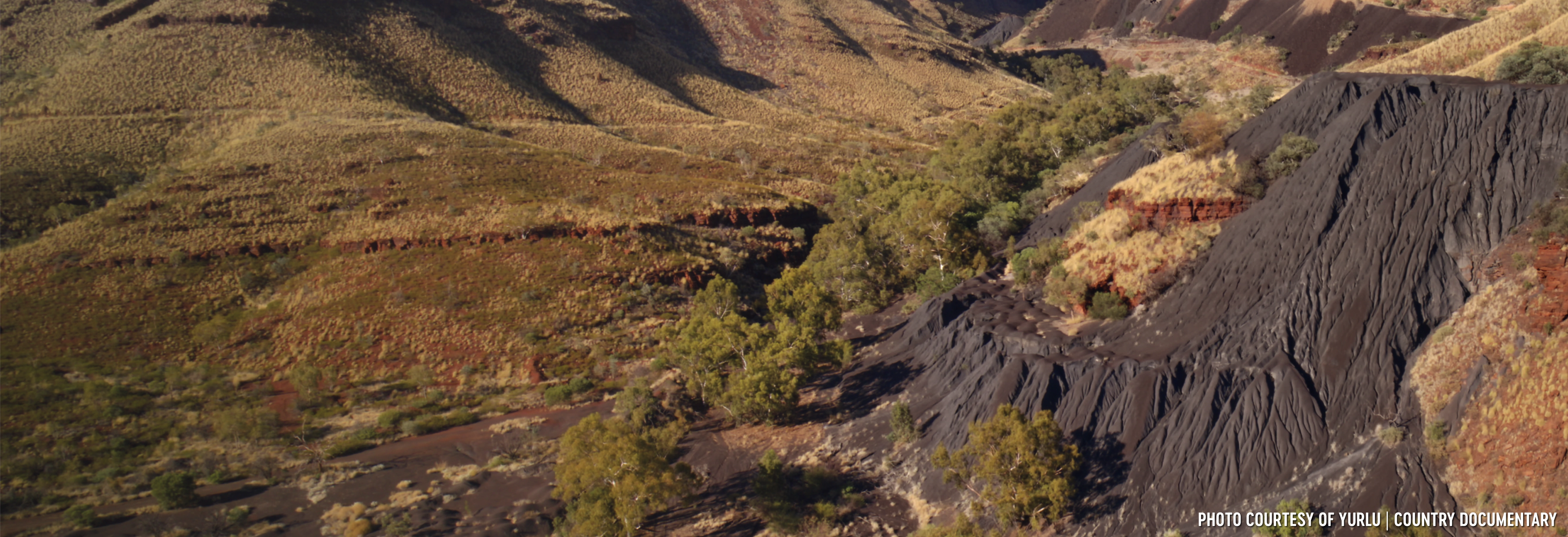 Banjima Country, WA. Wittenoom mining site showing dark blue coloured asbestos tailings