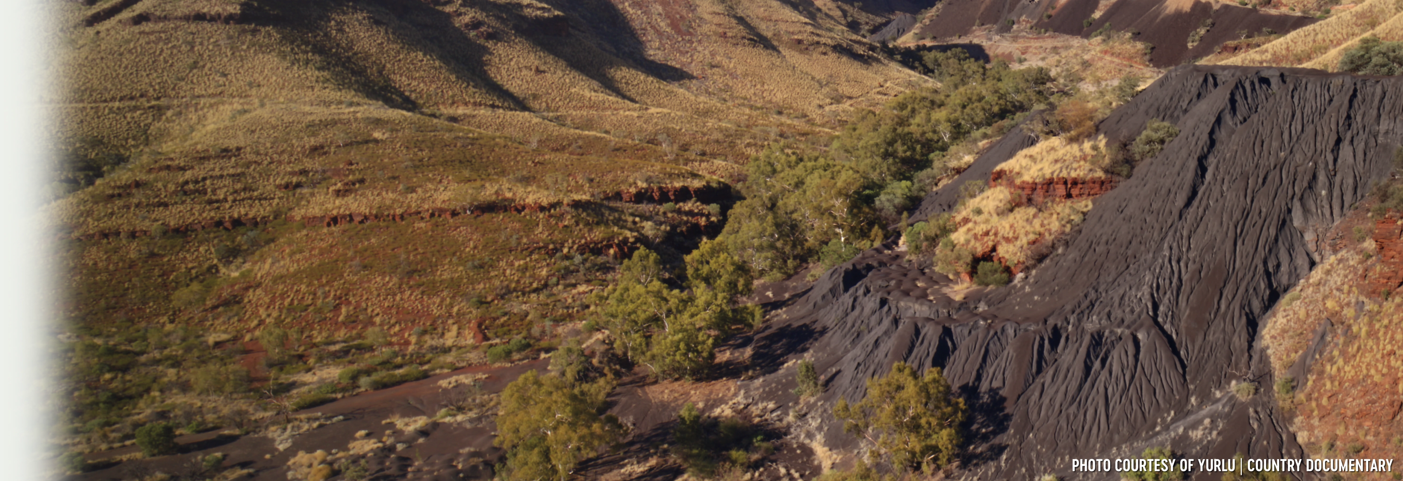 Banjima Country, WA. Wittenoom mining site showing dark blue coloured asbestos tailings