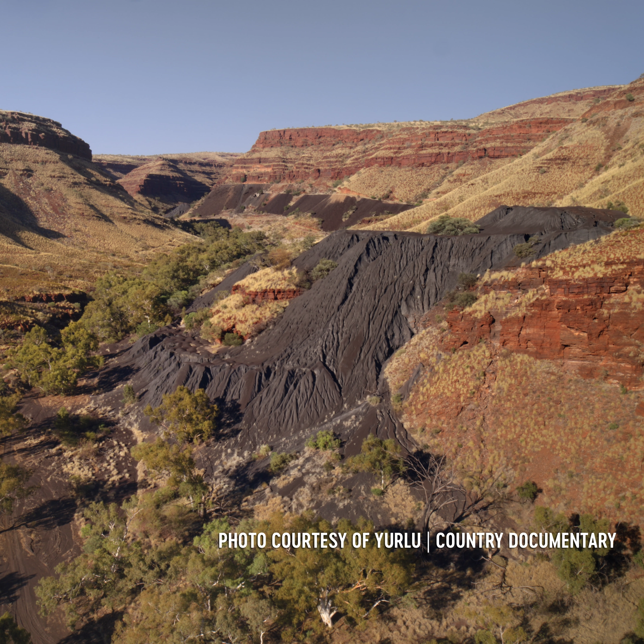 Banjima Country, WA. Wittenoom mining site showing dark blue coloured asbestos tailings